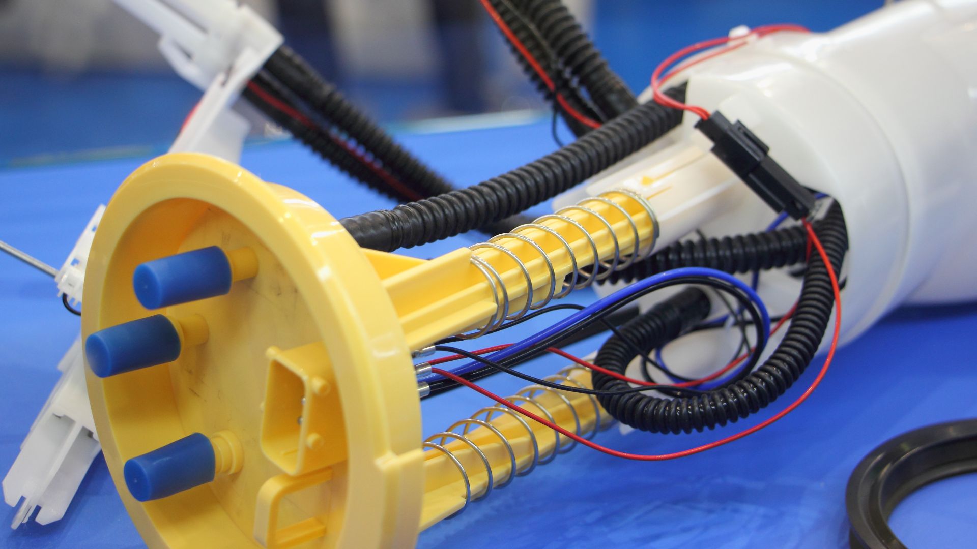a close up of a machine with wires attached to it.|a close up of a speedometer with yellow arrows.