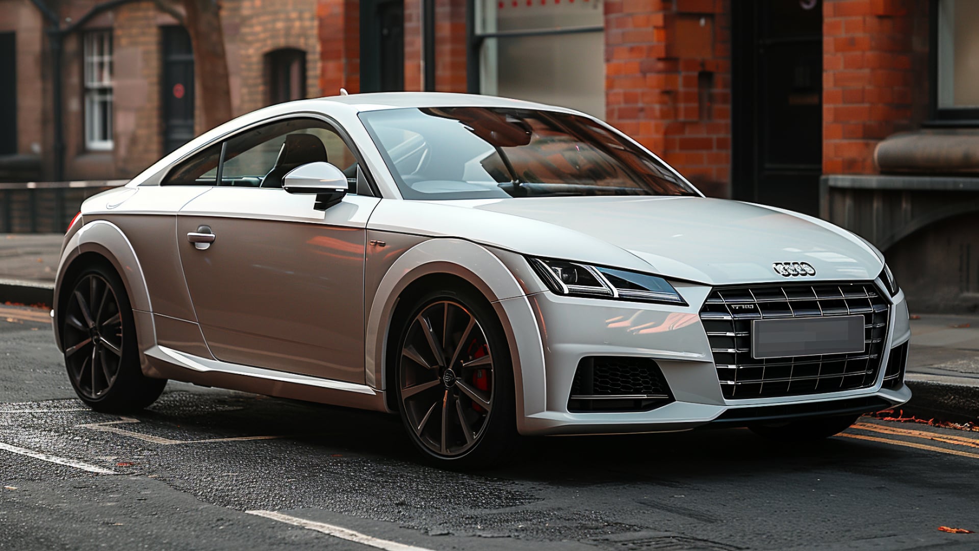 A white Audi TT, from one of the years to avoid, parked on the side of a street.|a white car parked on the side of the road.