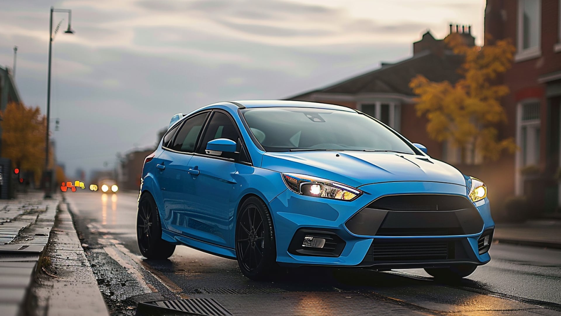 A blue Ford Focus ST, not from the years to avoid, driving down a city street.|a blue ford focus st driving down a road.