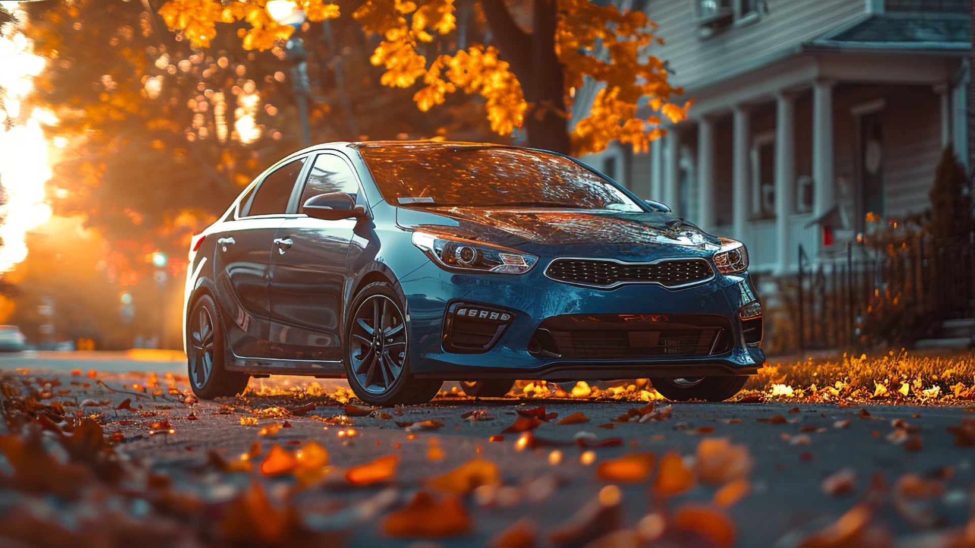 A blue Kia Rio, a model distinct from the Kia Forte years to avoid, parked on a street with autumn leaves.|a blue car parked in front of a building.