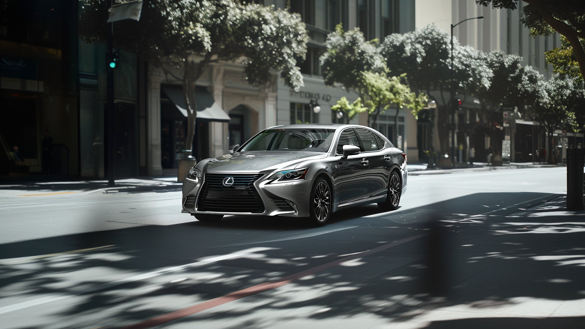 The 2019 Lexus LS 460 is driving down a city street.|a silver car driving down a road next to a hill.