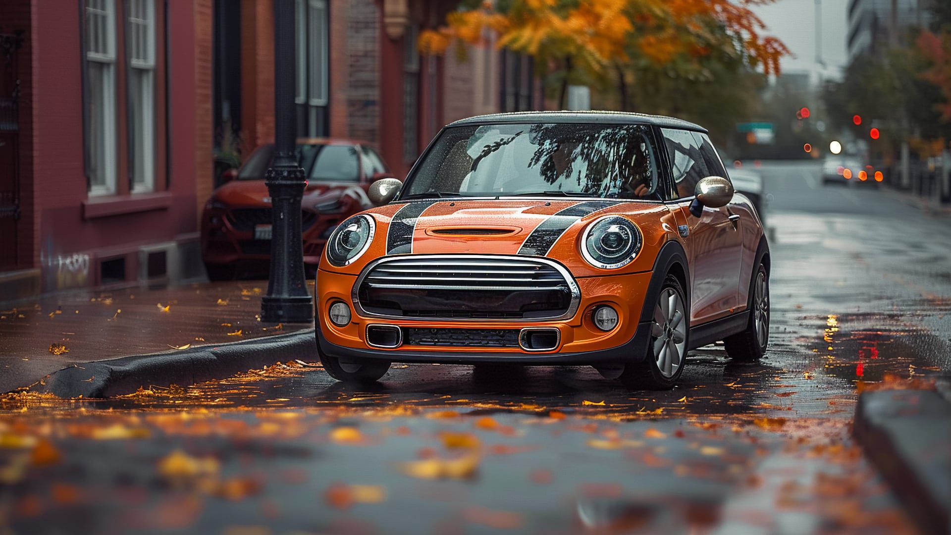 A Mini Cooper parked on the side of a road.|an orange and black mini car driving down a street.