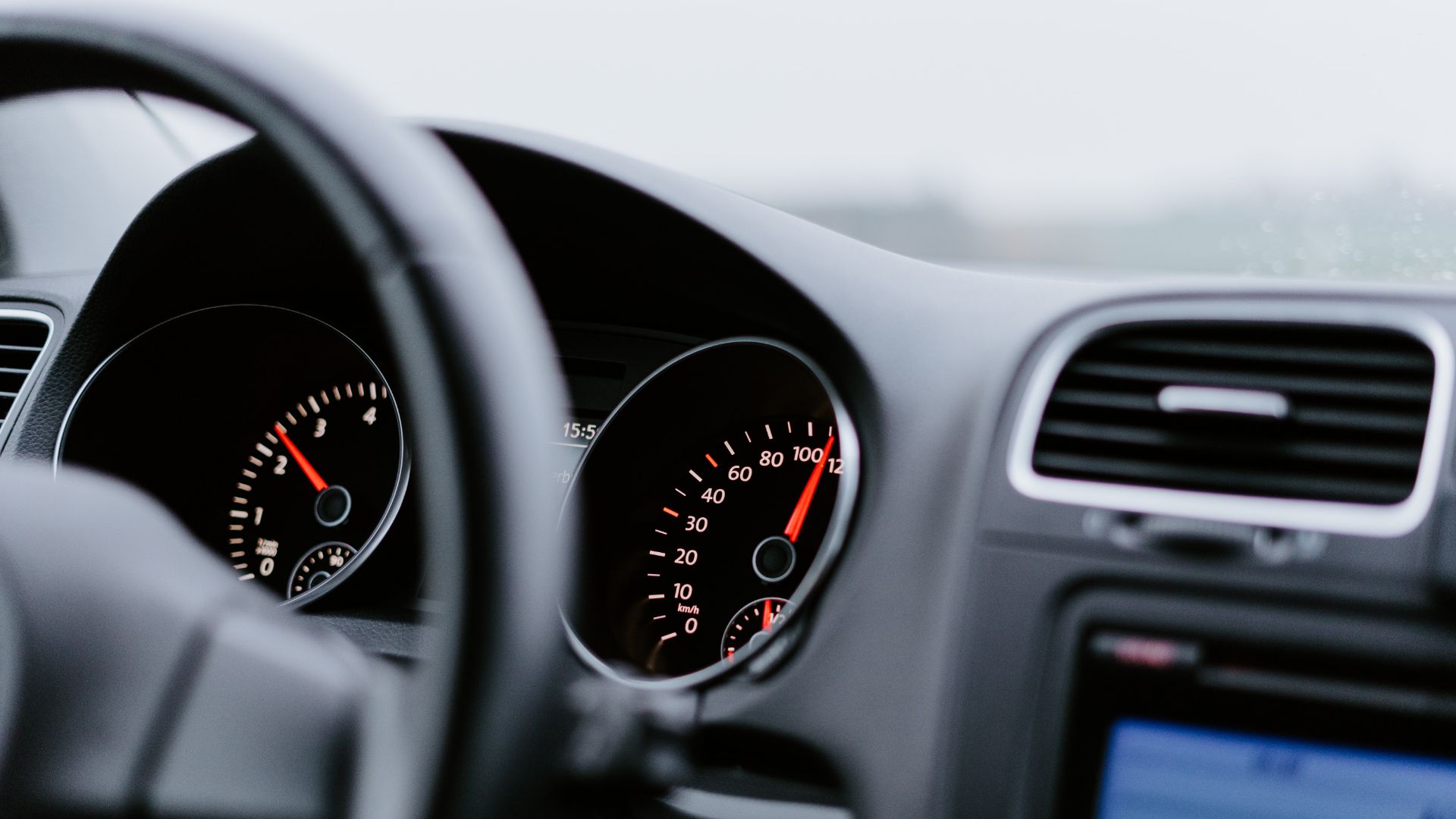 the dashboard of a car with a speedometer.|a close up of a car engine with its hood up.|a close up view of a motorcycle engine.|a close up of a metal structure with many gears.|a close up shot of a large engine.|a man working on a car engine in a garage.