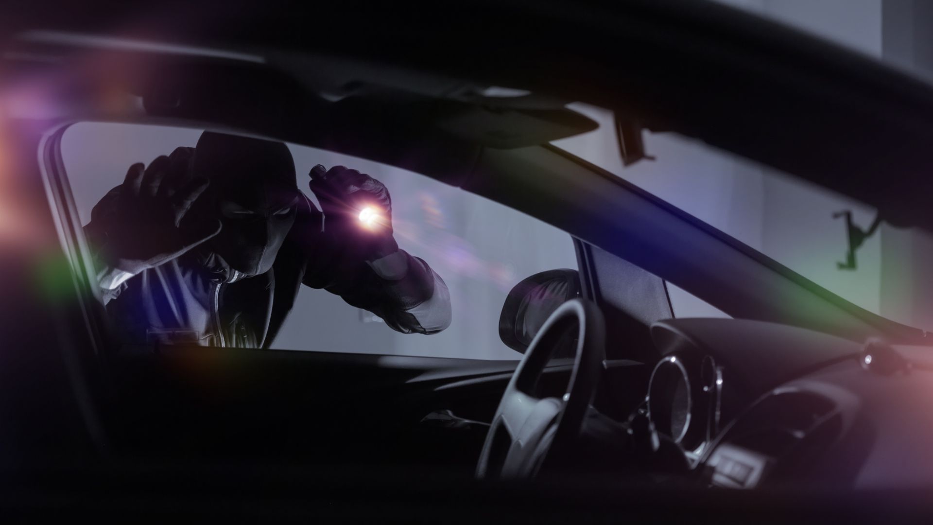 a car's interior is shown with the sun shining through the window.|a close up of a remote control on a car.
