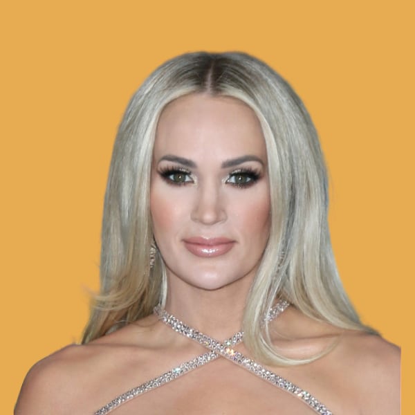 a woman with blonde hair wearing a silver dress.