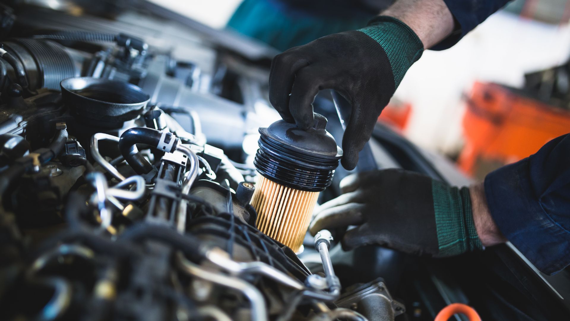 a man is working on a car engine.|a man is working on a car engine.