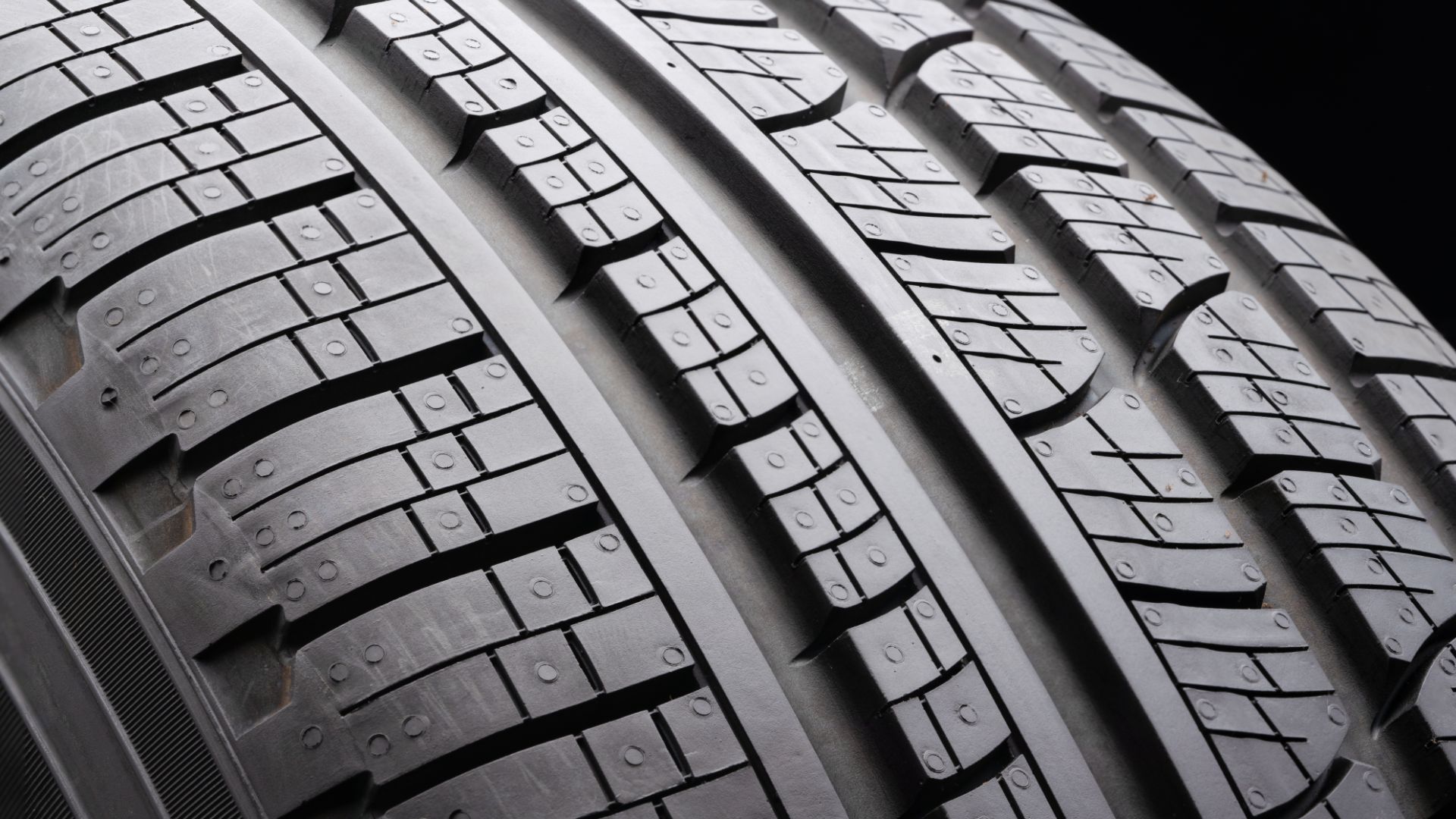 a close up of a tire on a black background.
