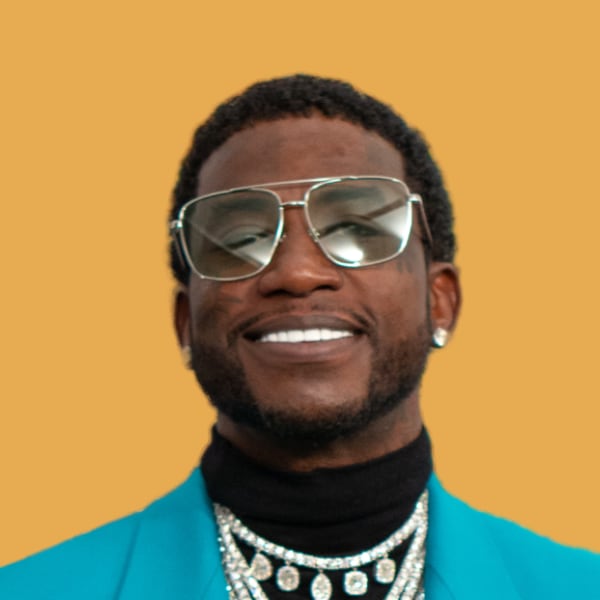 a man wearing a blue jacket and silver sunglasses.