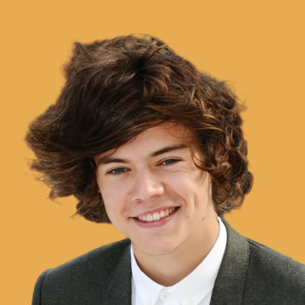 a young man with curly hair wearing a suit.