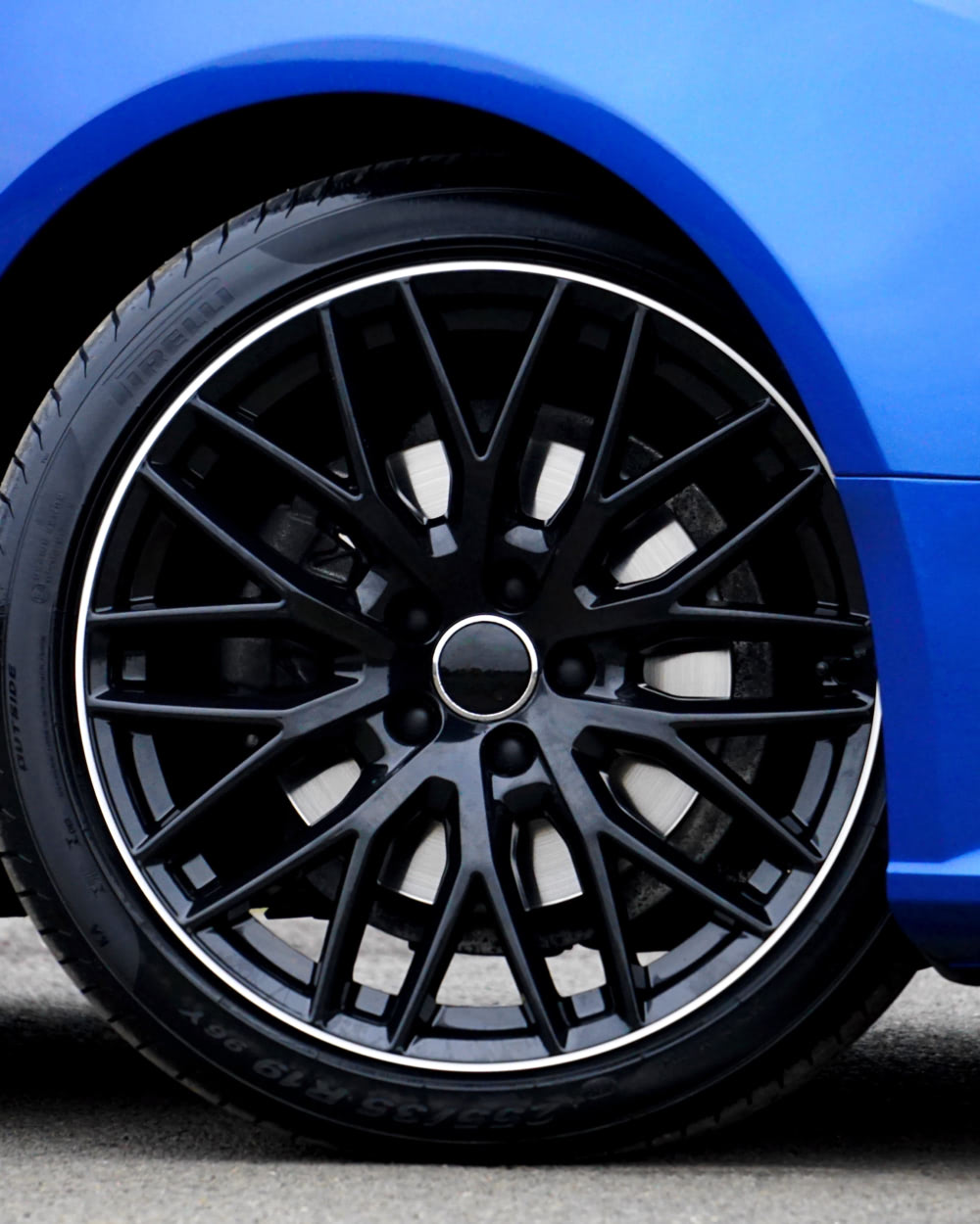 A close up of a blue car tire.