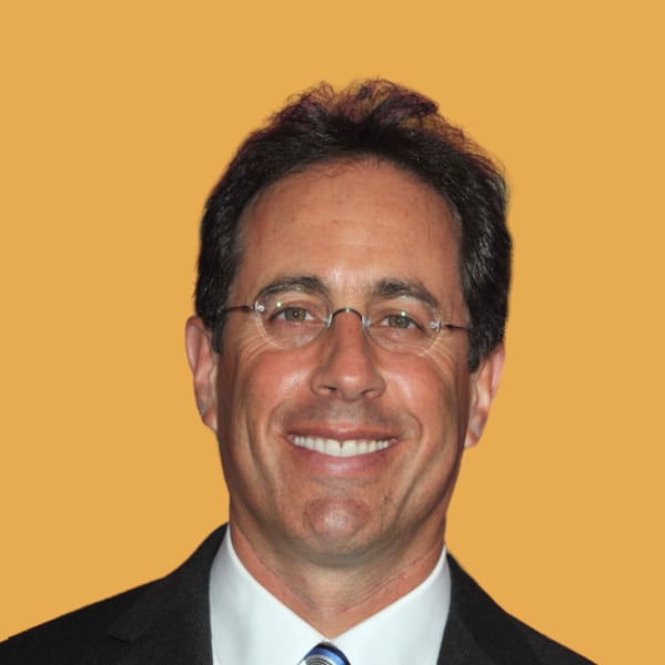 a man in a suit and tie smiling.