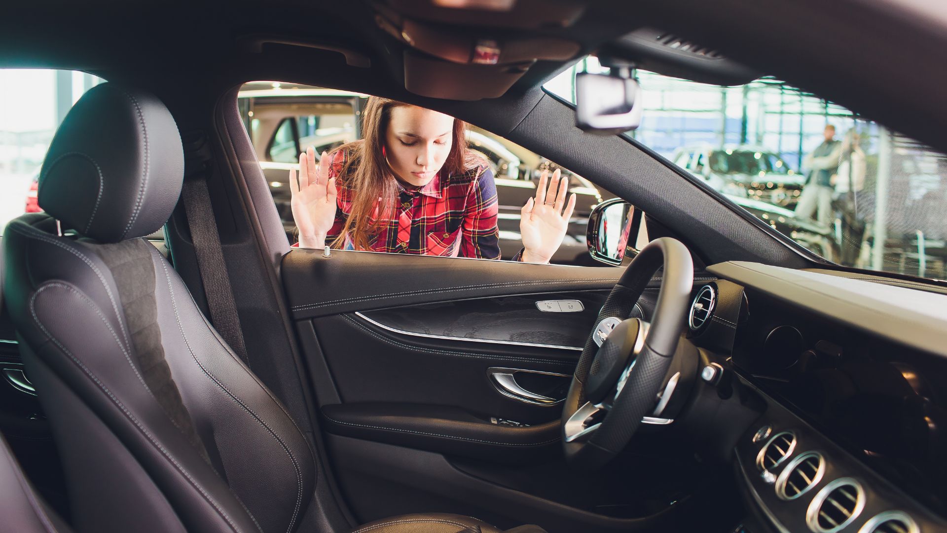 a woman sitting in the driver's seat of a car.|a man is opening a door with a key.