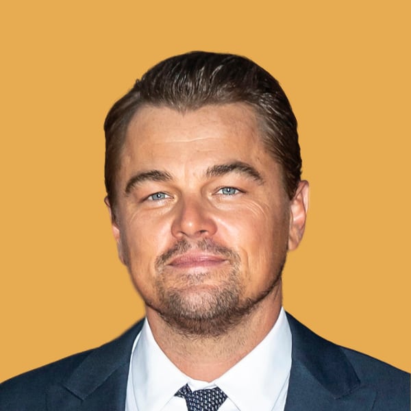 a close up of a person wearing a suit and tie.