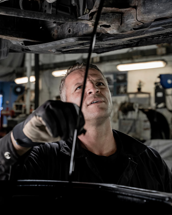 A man working on a car in a garage.