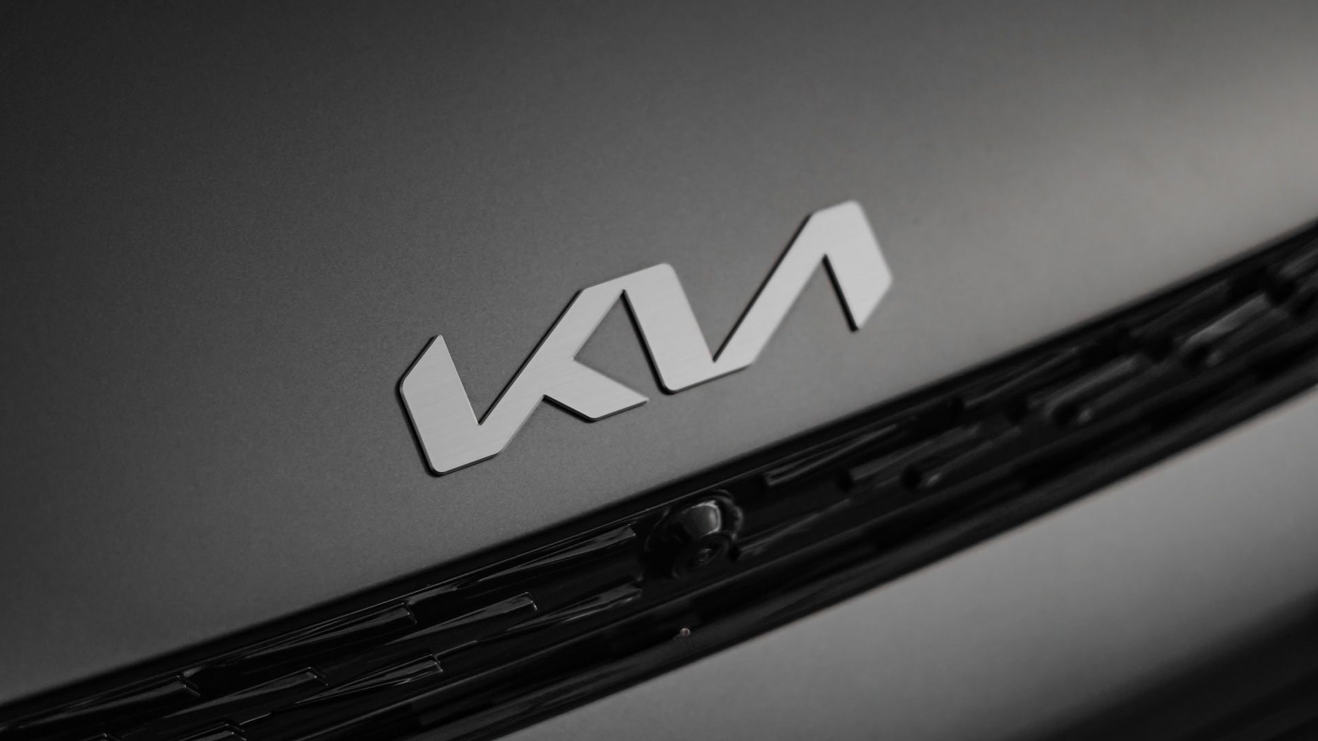 a close up of the logo on the front of a car.|the logo for the kla movement and the movement that inspires.|a close up of a car on a city street.|a black and red logo next to a white logo.|a pie chart showing the number of letters in each letter.