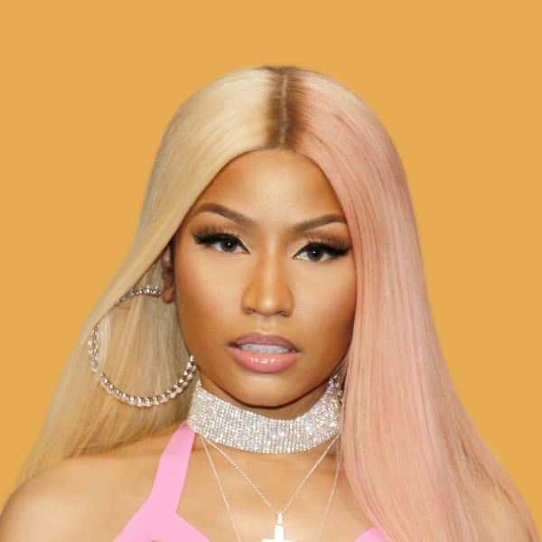 a woman with blonde hair wearing a pink top.
