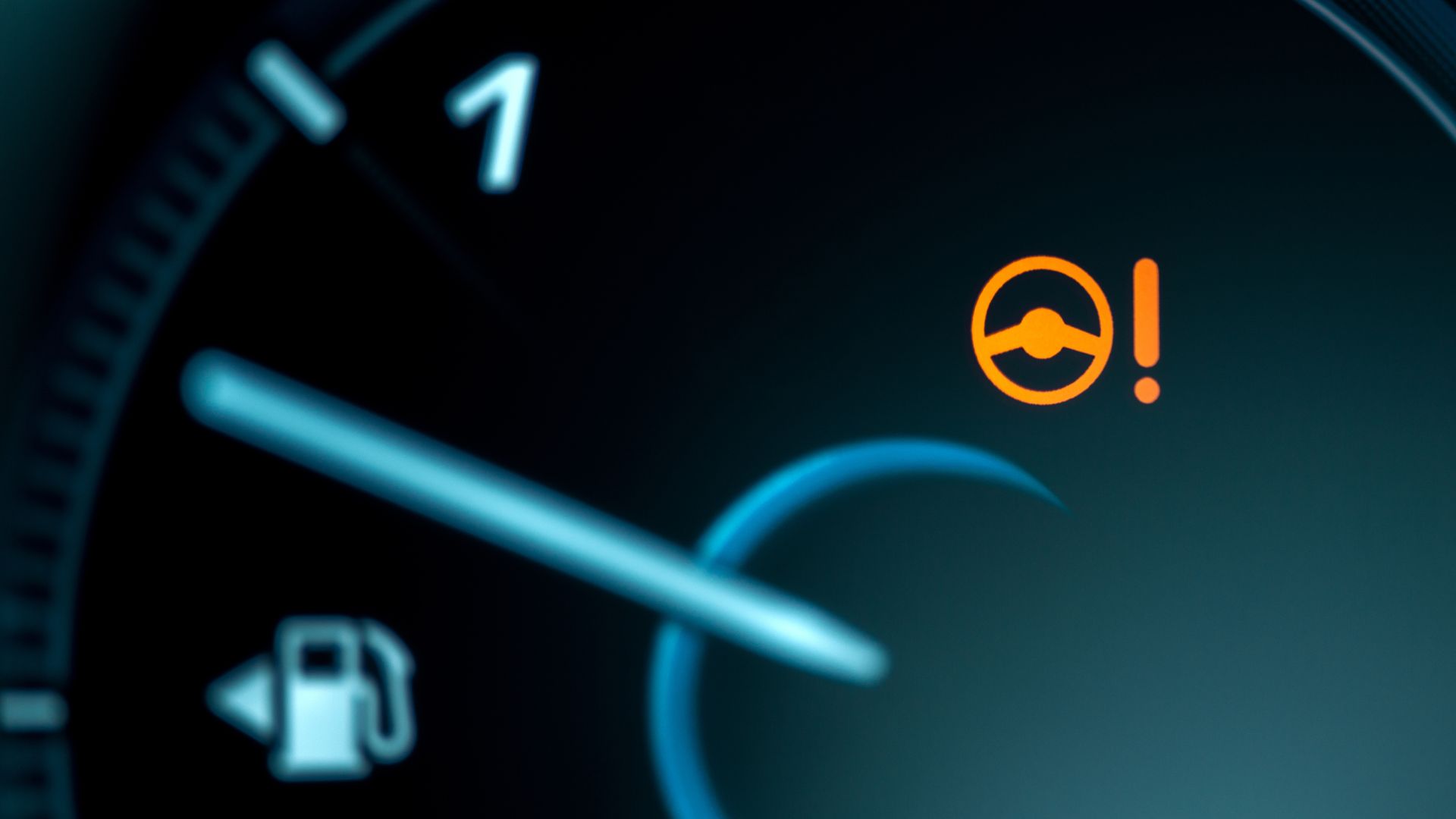 a close up of a car's fuel gauge.|a close up of a bunch of pipes and hoses.