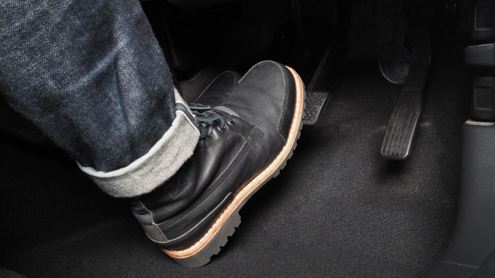 a close up of a person wearing a pair of shoes.|the front wheel of a white truck with a fuel can attached to it.