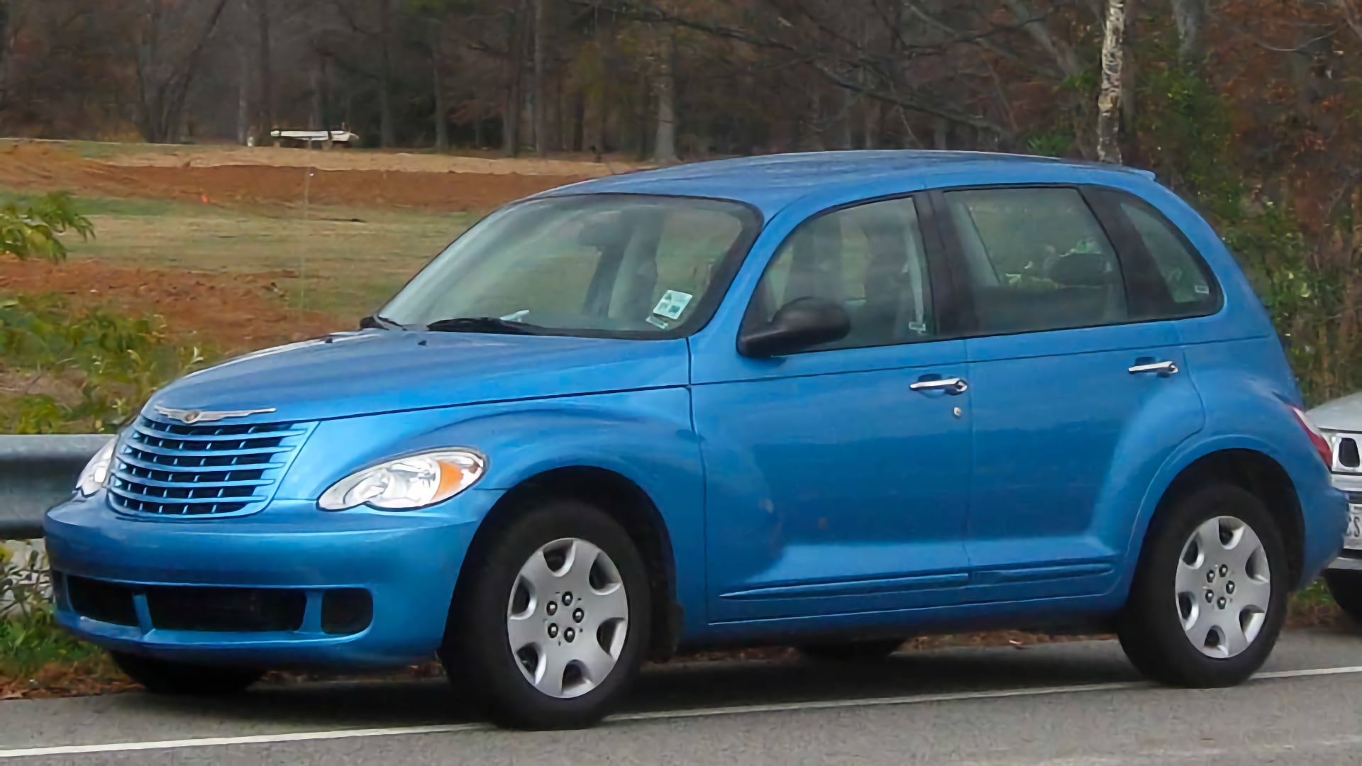 a blue car parked on the side of the road.