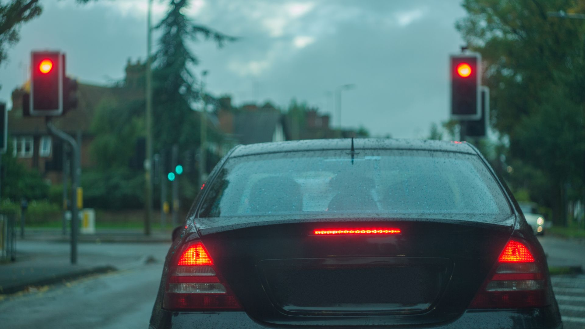 a car stopped at a red traffic light.|a close up of a person holding a gun.|a close up of a bunch of wires and wires.|a person is holding a small motor in their hand.|a person is working on a machine in the dark.|a man in blue gloves is working on a car engine.