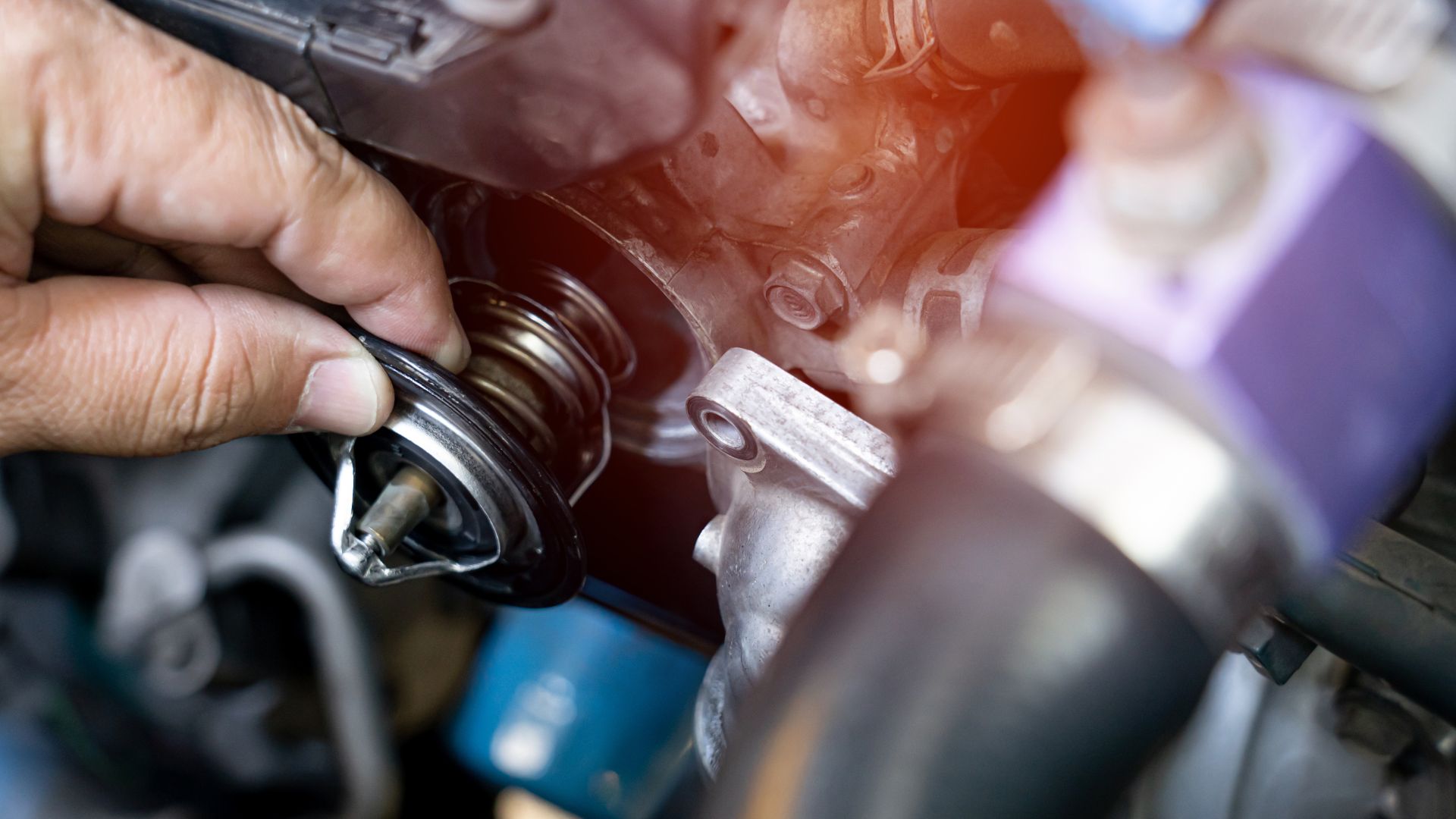 a close up of a person working on an engine.|a close up of a metal object on a black surface.|a person holding a metal object in their hand.
