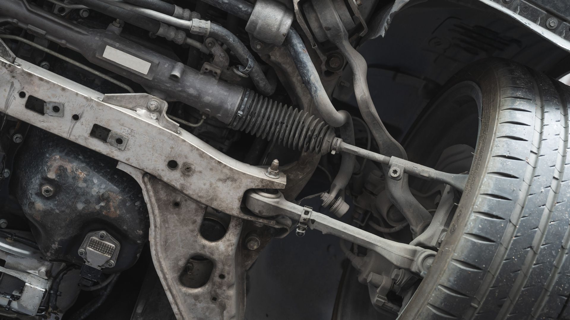 a close up of the front suspension of a vehicle.|a close up of the front suspension of a motorcycle.