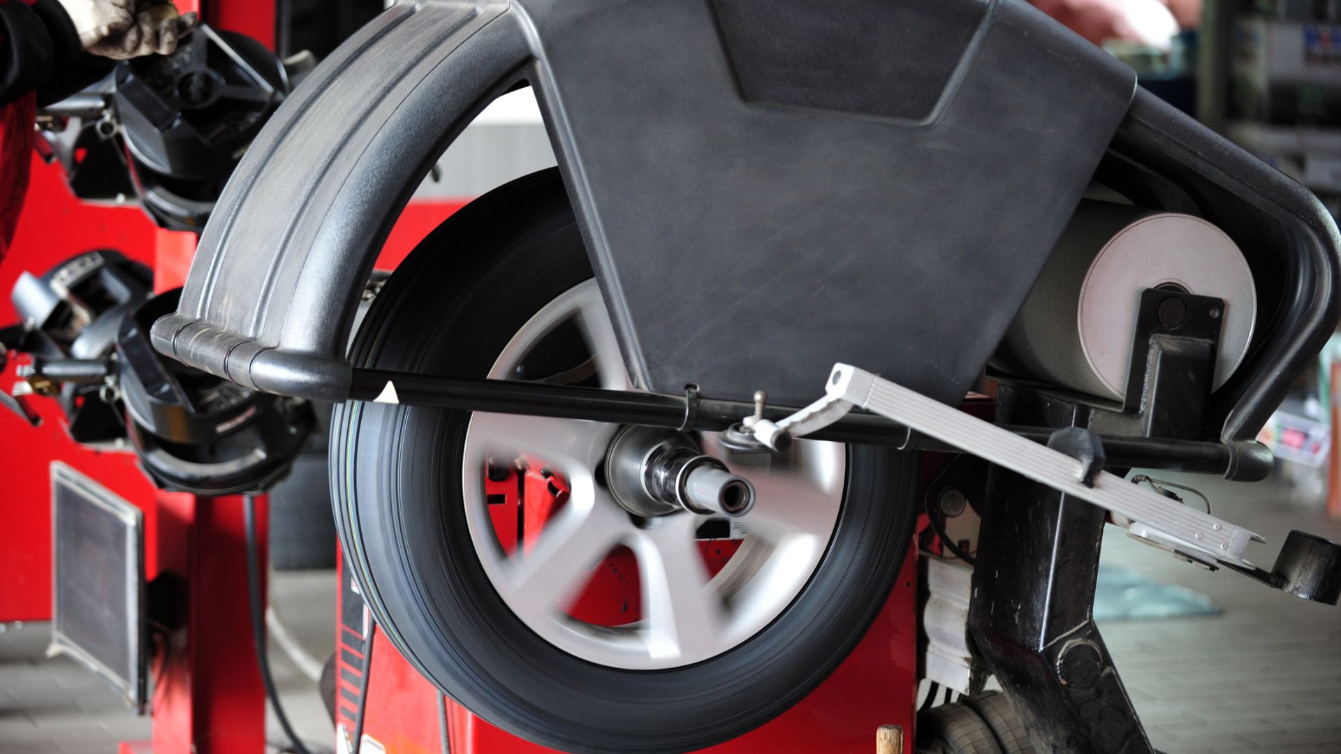 a close up of a wheel on a motorcycle.|a man working on a tire on a car.|a man working on a tire on a car.