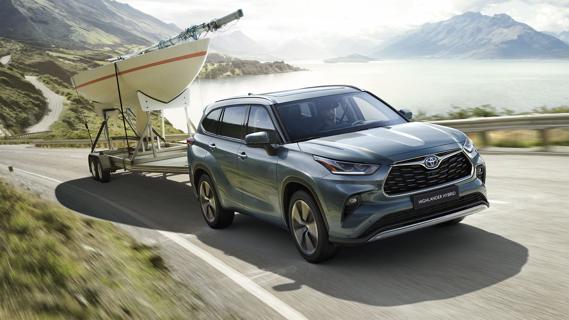 a blue suv towing a boat on a trailer.|a group of people standing in the back of a van.|the interior of a vehicle with black leather seats.