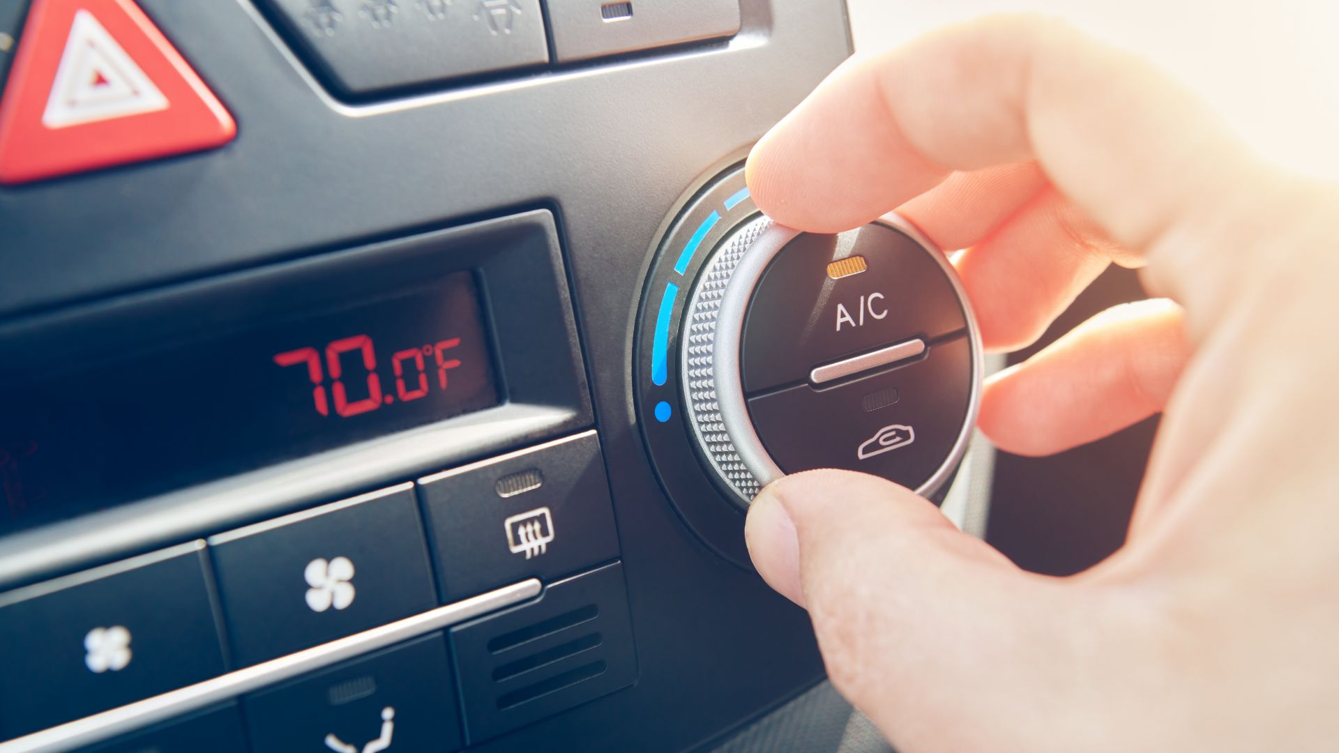 a person turning on a car's ac meter.
