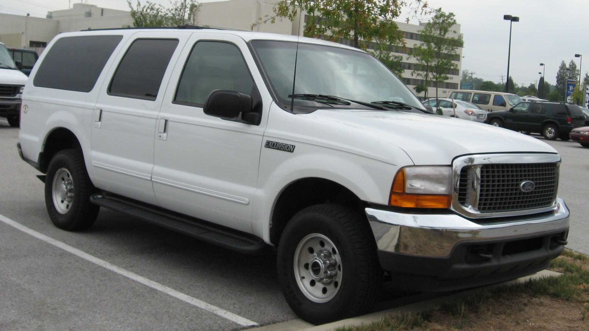 a white truck parked in a parking lot.